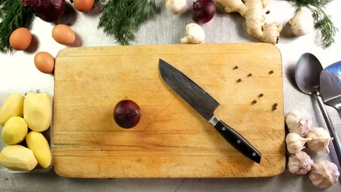 Top view chef cuts onion into half rings on chopping board Video stock 76113843