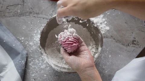 Top view of chef hands decorating marshmallow using powdered sugar from the Stock Footage 100173040