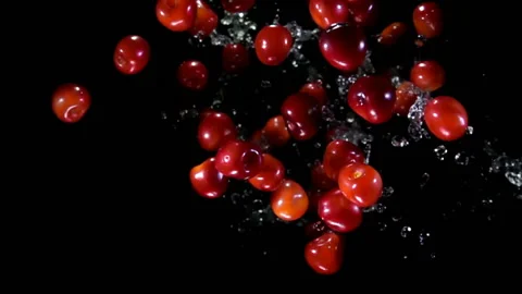 Top view of the cherries bouncing up on a black background with drops of water Stock Footage 160432808