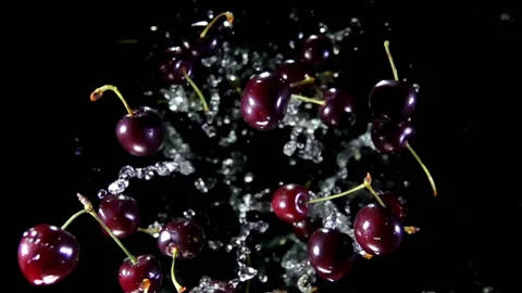 Top view of the cherries flying up on a black background with splashes of water Stock Footage 161162095