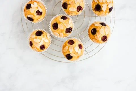Top view of Cherry Muffins on Cooling Rack over White Marble Background with  Stock Photos