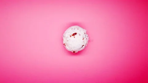 Top view chestnut and red bean ice cream ball melting timelapse on pink Stock Footage 107716086