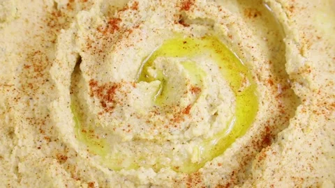 Top view of chickpea hummus with olive oil and smoked paprika circle rotation Stock Footage 237962351