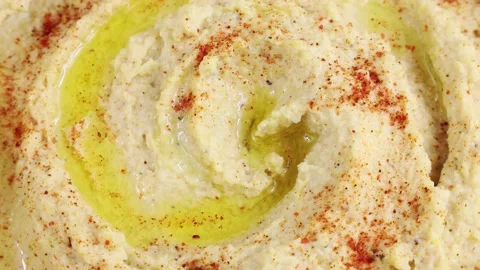 Top view of chickpea hummus with olive oil circle rotation Video stock 239076213