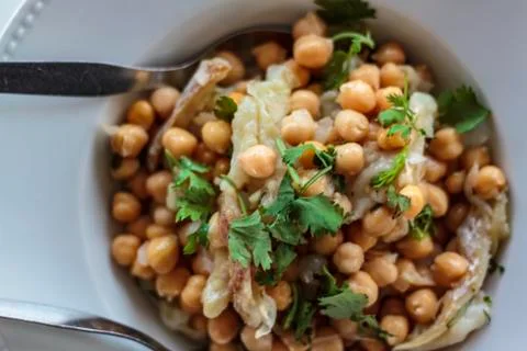Top view of chickpeas salad with cod and coriander Stock Photos