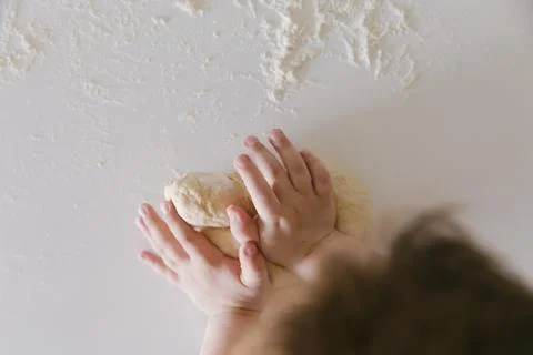 Top View of a Child Baking Bread Dough on Floured Surface Stock Photos