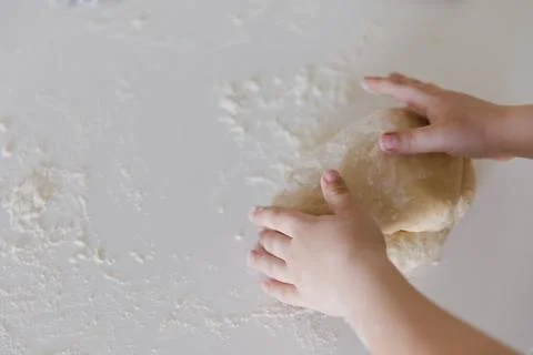 Top View of a  Child Baking Bread Dough on Floured Surface 스톡 사진