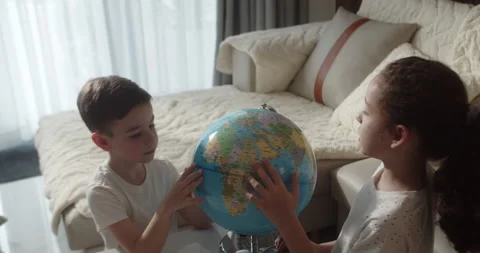 Top view children is studying while sitting at home in rays sunset in room. Kids Stock Footage 255678887