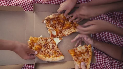 Top view of children's hands take slices of pizza with cheese, tomato sauce Stock Footage 203854170