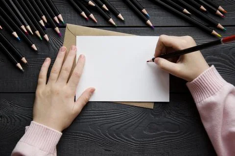 Top view of the child's hands lying on a sheet of white paper. Mockup Stock Photos