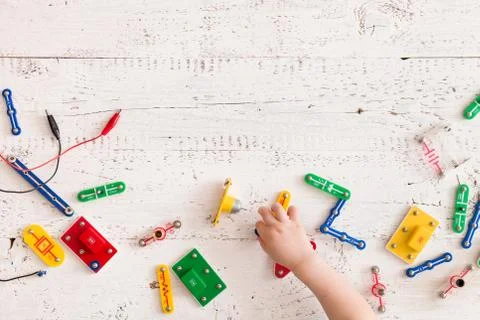 Top view on child's hands playing with electronic constructor and game at the Stock Photos