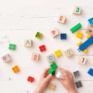 Top view of a child's hands playing with children's educational toys, colorful Stock Photos
