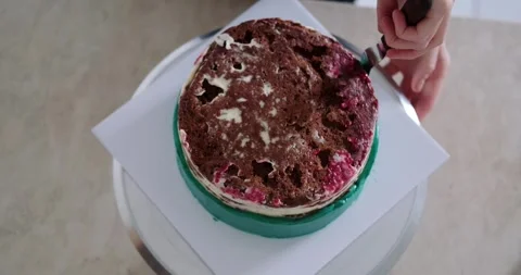 Top view of a chocolate cake with a raspberry layer that stands on a stand. Stock Footage 270794028