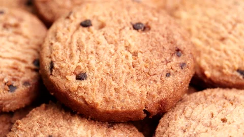 Top view chocolate chip cookies turning, rotating on table, slow motion Stock Footage 238533180