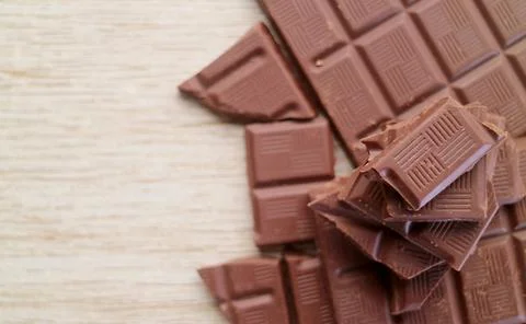 Top View of chocolate chunks pile on wooden background with copy space Stock Photos