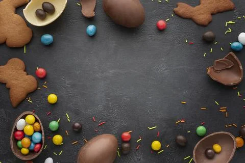 Top view chocolate easter eggs with candy cookies frame Stock Photos