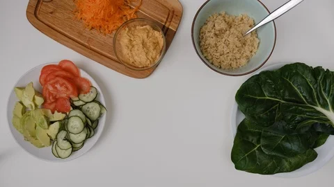 Top view chopped fresh vegetables and hummus. Cooking Salad. Stock Footage 125241753
