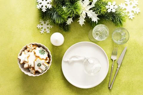 A top view of a Christmas table setting featuring an empty plate with ginge.. Stock Photos