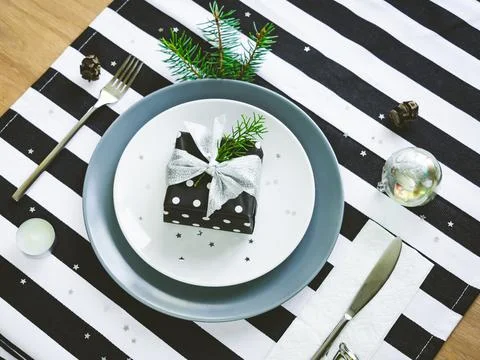 Top view of christmas table setting. A gift box in a plate. Stock Photos