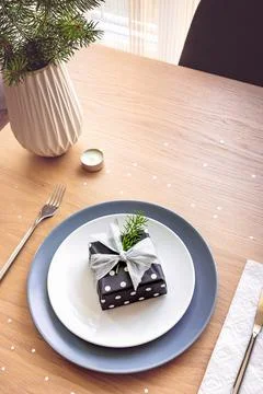 Top view of christmas table setting. A gift box in a plate. Stock Photos