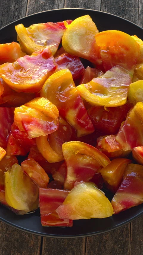 Top view of chunks of large Old German tomato on a plate. Video stock 345087316