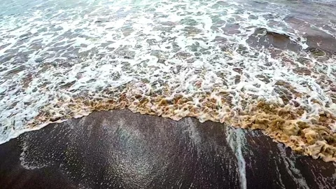 Top view of cinematic 4k shot of waves coming on beach Stock Footage 345321814