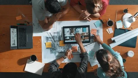 Top view of civil engineer using tablet to design house structure. Symposium. Stock Photos