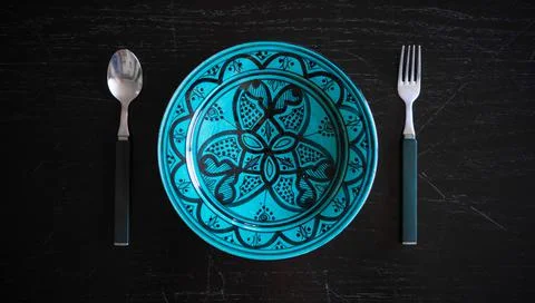 Top view clean arabic empty plate with knife and fork on the wood table Stock Photos