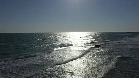 Top view of clear blue water with waves on a sandy beach. Stock Footage 221183124