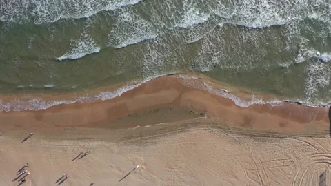Top view of clear blue water with waves on a sandy beach. Stock Footage 221183189