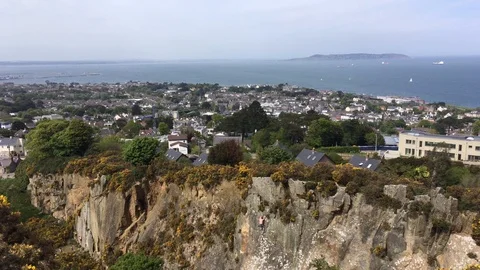 Top View of Cliff face and a Sea-Side Town From Hilltop In Killiney, Ireland Stock Footage 89976935