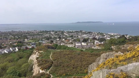 Top View of Cliff face and a Sea-Side Town From Hilltop In Killiney, Ireland Stock Footage 89977667