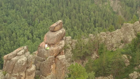 Top view a climber pulls a safety rope while sitting on top of a mountain. Vídeo Stock 135540334