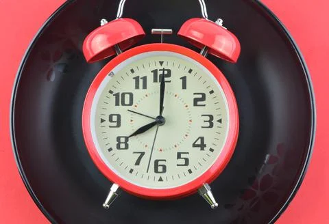 Top view of clock and black plate Stock Photos