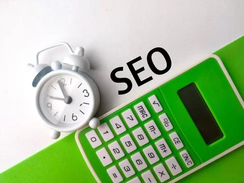 Top view clock and calculator with text SEO Stock Photos