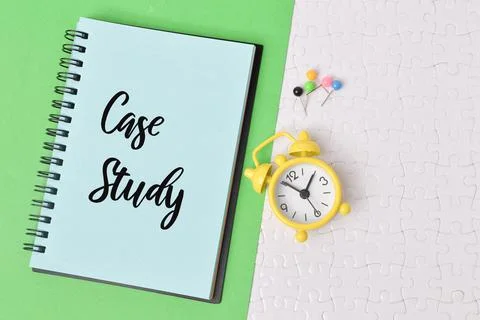 Top view of clock and notebook written with CASE STUDY Stock Photos