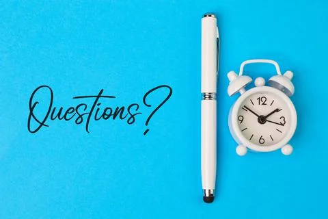 Top view of clock and pen isolated on a blue background written with QUESTION Stock Photos