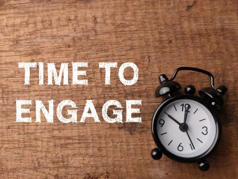 Top view clock and text TIME TO ENGAGE on wooden background. Stock Photos