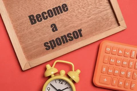 Top view of clock, calculator and brown board written with BECOME A SPONSOR. Foto stock