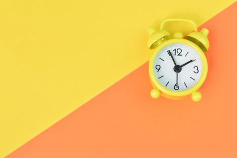Top view of clock isolated on yellow and orange background with copy space Stock Photos