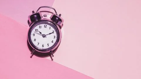 Top view clock pink background Stock Photos