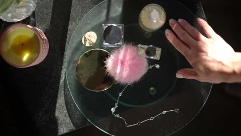 Top view close-up bijouterie and cosmetics on glass tray with slim female hand Stock Footage 221863692