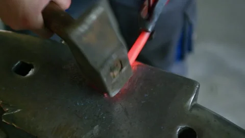 Top View Close-Up of Blacksmith Hammering Hot Metal on Anvil Stock Footage 313850945