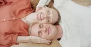Top View Close Up Of Couple Kissing And Cuddling Lying On Floor At Home Stock Footage