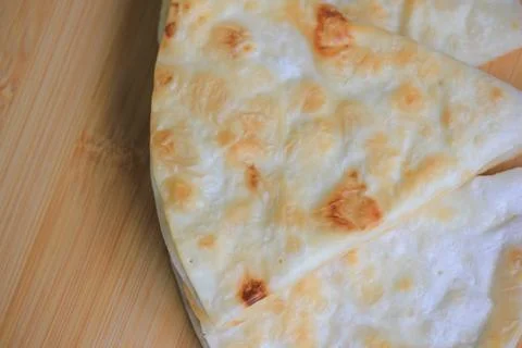 Top view close up of crispy layered flatbread on a wooden board with copy s.. Stock-Fotos