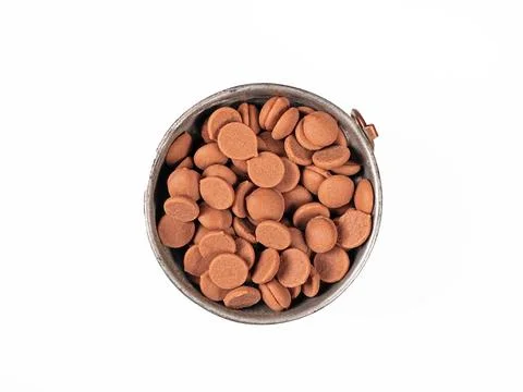 Top view close-up of a cup filled with chocolate granules on white background Stock Photos