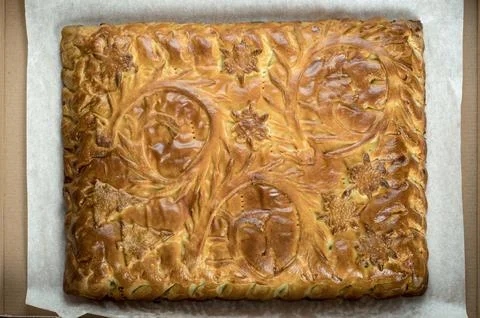 Top view close-up decorated pie with filling in a cardboard box. Stock Photos