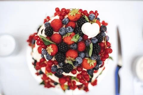 Top view close up of fruit wedding cake decorated with various berries at Stock Photos