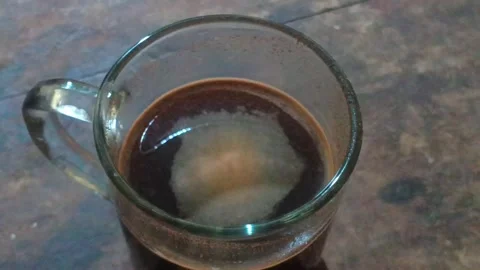 Top view close-up of a glass mug filled with hot black coffee. Stock Footage 321931803