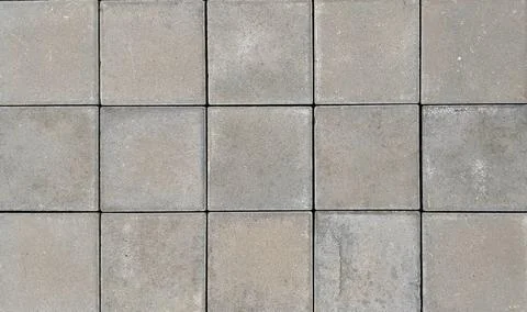 Top view close-up of grey square concrete paving slabs background texture. Stock Photos